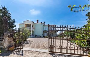 a large white house with a gate in front of it at 2 Bedroom Beautiful Apartment In Valtura in Valtura
