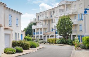 an empty street in front of apartment buildings at Amazing Apartment In Vaux-Sur-Mer in Vaux-sur-Mer