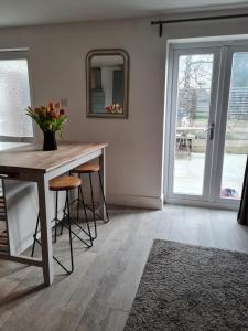a dining room with a table and chairs and a window at The Little Cottage - Peaceful, Dog Friendly Cottage in 5 Acres in Glastonbury