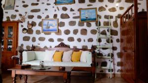 a living room with a couch and a table at Vintage White House Patmos in Patmos