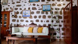 a living room with a couch and a table at Vintage White House Patmos in Patmos