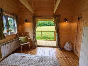 a bedroom with a bed and a window in a cabin at Raleigh Lodge in Bideford