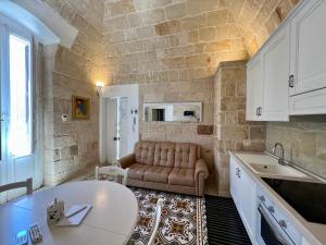 a living room with a couch and a table at Vittorio Emanuele Apartment in Monopoli