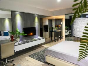 a bedroom with a large bed and a bathroom at Lavenderbnb Room 8 at Mataram City in Yogyakarta