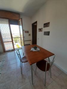 雷焦艾米利亞的住宿－A casa di Annamaria，一间带木桌和椅子的用餐室