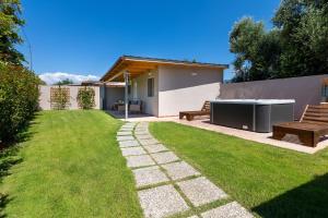 a backyard with two benches and a table and a lawn at Messinian Monte e Mare in Kalamata