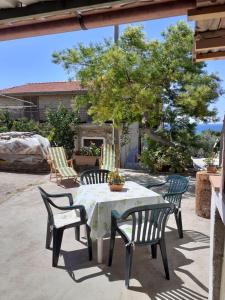 a table and four chairs on a patio at G&M Holiday Home 2 in Minturno