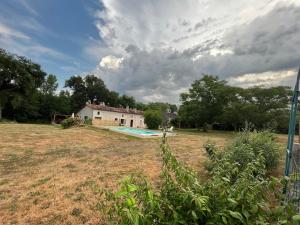 une cour avec une piscine et une maison dans l'établissement Maison Périgord vert piscine et spa, à La Roche-Chalais