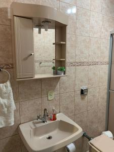 a bathroom with a sink and a mirror at Casa Aconchego II in Pomerode