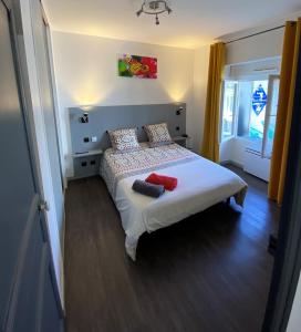 a bedroom with a bed with two pillows on it at Résidence Pierre François in La Roche-sur-Yon