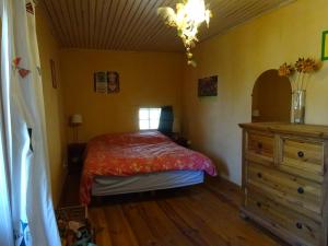 a bedroom with a bed and a dresser at Maison de charme à Saoû, avec beau jardin au calme in Saou +8 photos