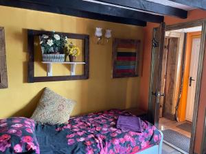 a bedroom with a bed and a mirror at Yarm cottages the byre in Kirk Leavington