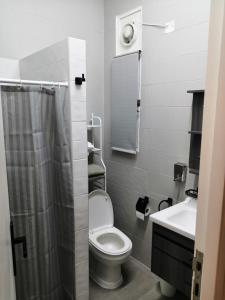 a bathroom with a toilet and a sink at The Blue Gate 6 in Muscat