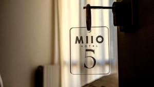a sign on a door that reads milo nuclei at MIIO HOTEL in San Vincenzo