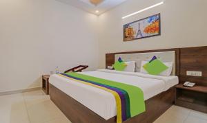 a bedroom with a large bed in a room at Treebo Trend Magnum Chandigarh in Mohali