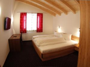 een slaapkamer met een bed en een rood raam bij Apart Bergreich in Längenfeld