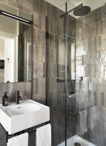 ein Bad mit einem Waschbecken und einer Dusche in der Unterkunft 46heima Boutique Apartments in Reykjavík