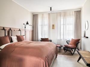 En eller flere senge i et værelse på 46heima Boutique Apartments