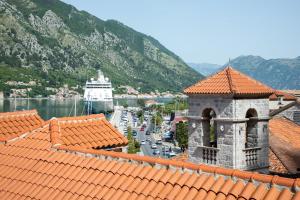a view of a harbor with a boat in the water at Vincenza Apartment in Kotor