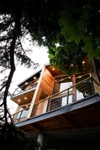a building with a balcony on the side of it at Luxury Alpine Treehouse in Holladay