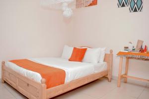 Un pat sau paturi într-o cameră la INZOZI AFRICA HOUSE B&B- Kacyiru