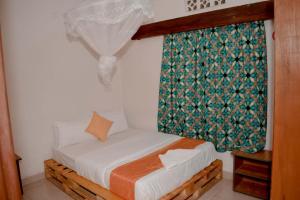 En eller flere senger på et rom på INZOZI AFRICA HOUSE B&B- Kacyiru