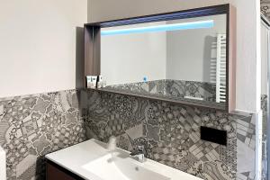 a bathroom with a sink and a mirror at Continental Hotel in Lovere