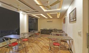 a room with tables and chairs and a bar at Treebo Trend Magnum Chandigarh in Mohali