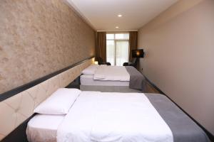 Postel nebo postele na pokoji v ubytování PENTAHOR HOTEL