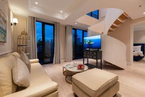 a living room with a couch and a tv at Louis Mo Apartment in Da Nang