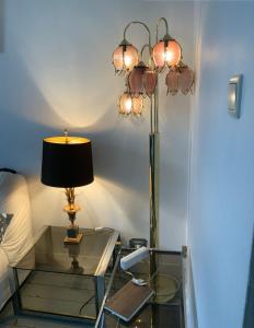 einem Glastisch mit einer Lampe darüber in der Unterkunft Cozy studio near Nato in Brüssel
