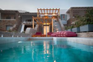 una piscina con sillas y una casa en Villa Piccolo Mondo, en Kalafatis