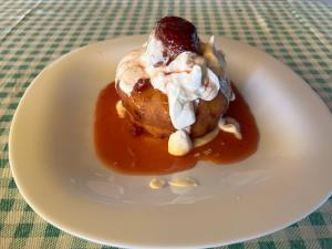 a white plate with a dessert on a table at Claudia in Eforie Sud