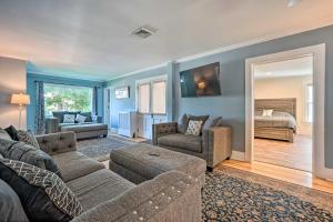 a living room with a couch and a bed at Downtown Retreat with Grill, Fire Pit and Wet Bar in Lake George