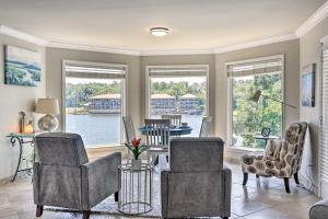 a living room with chairs and a table and windows at Beachy Hot Springs Condo with On-Site Lake Access! in Hot Springs