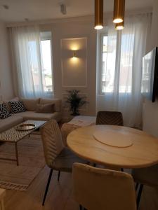 a living room with a table and a couch at Saint Raphael's apartment, classé 3 étoiles in Saint-Raphaël