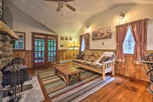 a living room with a couch and a table at Cabin with Trails and Creek! 23 Mi to Camelback Slopes in Greentown