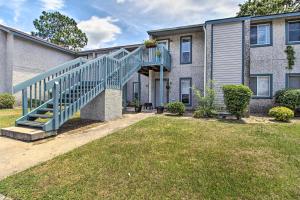 a house with a blue staircase in the yard at Hinesville Condo Grill, 4 Mi to Fort Stewart in Hinesville