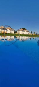 a large body of water with houses in the background at Ktima Ayia Marina in Amalias