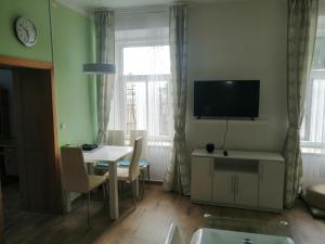 a living room with a table and a tv on the wall at Apartmán Šumperk in Šumperk