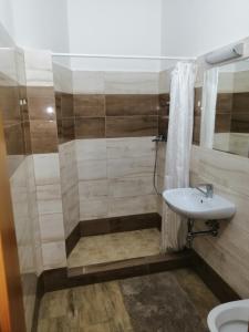 a bathroom with a sink and a shower at Apartmán Šumperk in Šumperk
