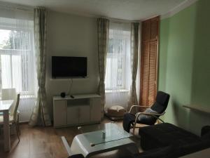 a living room with a couch and a tv at Apartmán Šumperk in Šumperk