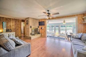 a living room with two couches and a fireplace at Lakefront Wisconsin Cottage with Dock and Hot Tub! in Crivitz