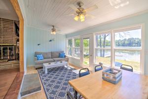 a living room with a couch and a table at Lakefront Wisconsin Cottage with Dock and Hot Tub! in Crivitz