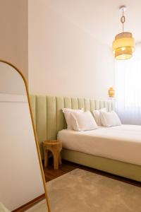 a bedroom with a large bed with white pillows at ORM- Flores Apartment in Porto +93 photos