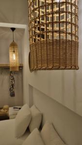 a living room with a couch and a hanging basket at Hotel Alexandra in Skala