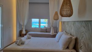 a bedroom with a large bed and a window at Hotel Alexandra in Skala