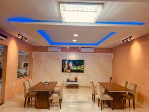 a dining room with two tables and chairs and a tv at Balneário Caratininga in Graça