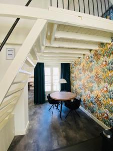 a room with a table and a mural on the wall at Slot Oostende in Goes