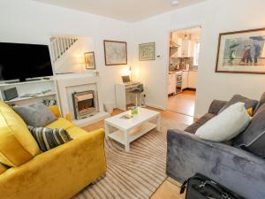 a living room with a couch and a fireplace at Avaelie House in Hebden Bridge